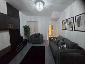 a living room with a couch and a television at Lily in Blackpool +3 photos