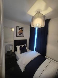 a bedroom with two beds and a chandelier at Lily in Blackpool