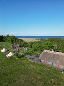 an aerial view of a building and tents and the ocean at Abruka Boutique Spa in Abruka