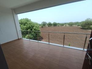 a large balcony with a view of a field at Matoshree Guesthouse in Akalkot