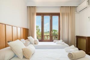 a hotel room with two beds and a window at Villa Son Ferriol in Palma de Mallorca +40 photos