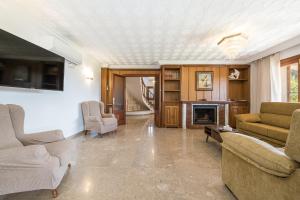 a living room with a couch and a fireplace at Villa Son Ferriol in Palma de Mallorca