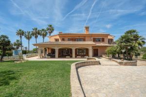 a large house with palm trees in front of it at Villa Son Ferriol in Palma de Mallorca