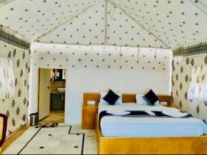 a bedroom with a bed with a canopy at Serendipity desert Camp in Thar Desert in Jaisalmer