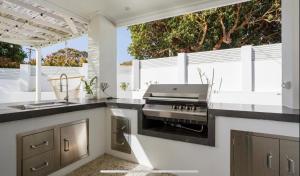 a kitchen with a stove top oven in a kitchen at Turquoise Waters Retreat in Perth