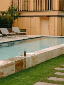 a bird sitting on the edge of a swimming pool at Gasthof Hirschen Schwarzenberg in Schwarzenberg im Bregenzerwald