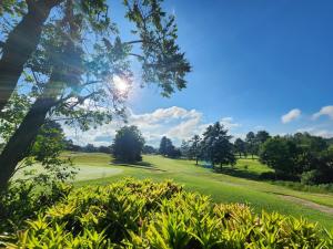 a view of a golf course with trees and grass at Kensington Lodge Golf Estate Villa - 17 Pinehurst Drive in White River