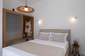 A bed or beds in a room at Rizes Villas Santorini with private pool