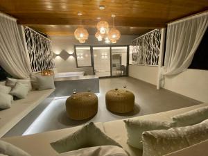 a living room with two chairs and a couch at Alexandrina in Mola Kalyva +85 photos