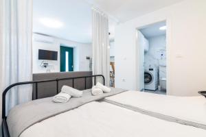 a bedroom with a bed with two towels on it at Studio apartment Ičići by the sea in Ičići