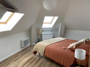 a bedroom with skylights and a bed in a attic at Chez Aline & Seb in Boulogne-sur-Mer