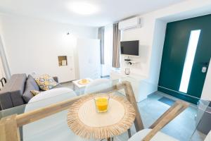 a living room with a glass table and a couch at Studio apartment Ičići by the sea in Ičići