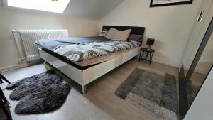 a bedroom with a bed and a rug at sunny City Apartment in Villingen-Schwenningen