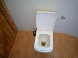 a bathroom with a white toilet in a stall at Rhino hillside in Sekenani