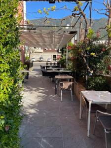 un patio con mesas y sillas bajo un dosel blanco en Hotel Betriu en Coll de Nargó