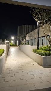 a walkway in front of a building at night at Sweethome Mummy@Youthcity Nilai in Nilai