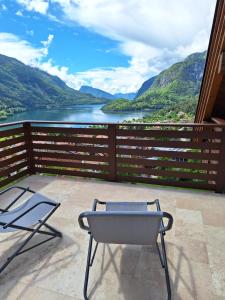 a patio with two chairs and a view of a lake at Casa Bellavista in Molveno