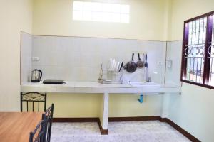 a kitchen with a white counter and a sink at Baanrimklong bungalow in Ko Chang