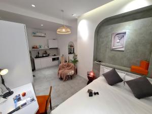 a bedroom with a bed and a kitchen with a table at Kin Wander Tan Quy in Ho Chi Minh City