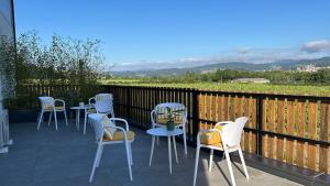 a group of chairs and tables on a balcony with a view at Alma Candida 11 in Valença +17 photos