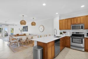 a kitchen with wooden cabinets and a table with chairs at NEW LISTING! Waterfront Villa 35 with boat slip townhouse in Marathon