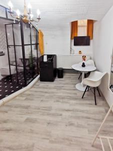 a living room with a table and chairs at Portos Boutique in Old Town Center in Braşov