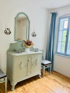 a bathroom with a dresser with a mirror on it at Na Nebi 187 in Bečov nad Teplou