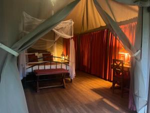 a bedroom with a bed in a tent at Ikweta Safari Camp in Maua