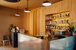 a bar with a counter and a shelf of alcohol at Le Agavi Resort & SPA in Saludecio