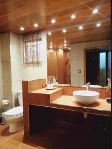 a bathroom with a sink and a toilet at CITI HOTEL in Hilongos