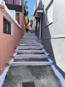 a street with snow covered steps between two buildings at Robert House in Samos