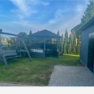 a playground with a gazebo and a swing at Gaspard in Sarbinowo