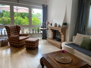 a living room with a couch and a fireplace at Ferienwohnung Schneider&Graf in Utting