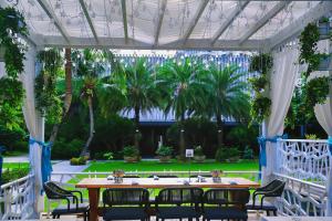 a table and chairs in a pavilion with palm trees at Wyndham Sanya Bay in Sanya