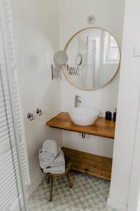 a bathroom with a sink and a mirror at NordseeEstate - Loft unter Reet mit Sauna in Tetenbüll
