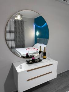 a bedroom with a bed and a mirror on a dresser at Erdi's Home in Berat