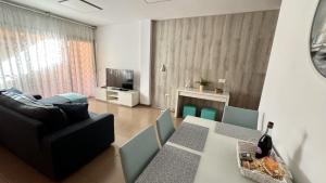 a living room with a couch and a table at Caleta Blue Ocean on the Beach by Deihu Experiences in Adeje