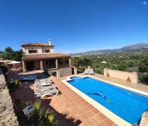 a villa with a swimming pool and a house at El Molar in Ronda