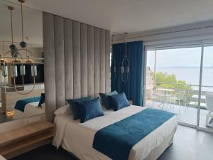 a bedroom with a large bed and a balcony at Canyelles Platja in Roses +128 photos