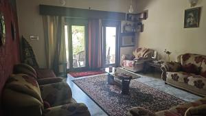 a living room with couches and a coffee table at Sweet Home 8 Chandigarh in Chandīgarh