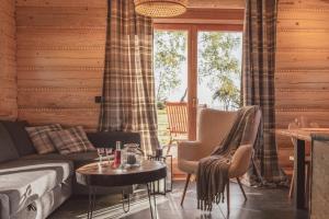 a living room with a couch and a table at Domki na Stecówce in Istebna +26 photos