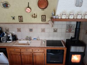 a kitchen with a sink and a stove at Maison de campagne avec piscine in Le Blanc +8 photos