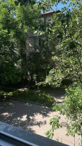 a view of a house with trees and a street at Evergreen Apart in Almaty