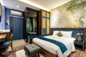 a bedroom with a bed and a desk and a bathroom at KunKin Garden Aparthotel in Ho Chi Minh City