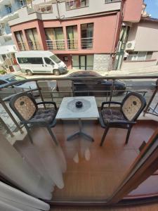 a table and chairs on a balcony with a table at Guest House Skalite in Sozopol