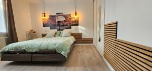 a bedroom with a large bed in a room at Maison 3 chambres avec piscine in Josse +2 photos