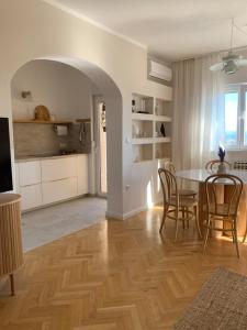 a kitchen and dining room with a table and chairs at Seaside Apartment Split in Šine
