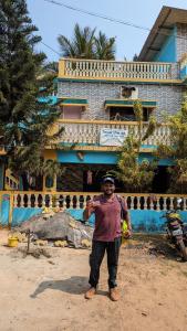 a man standing in front of a building at NISARG HOME STAY near Bus Stand Malvan in Malvan