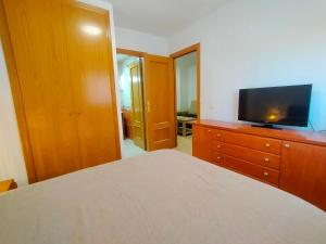 A television and/or entertainment centre at ACV - Costa Marina I-1ª linea planta 2 sur Még 13 kép