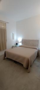 Rúm í herbergi á B&B Sperlonga